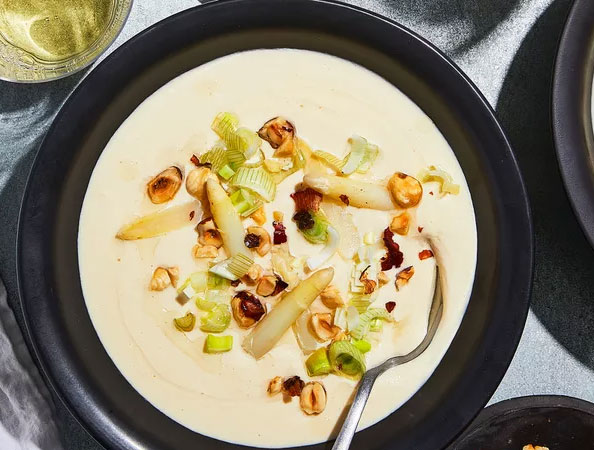 White Asparagus Soup with Pickled Ramps and Hazelnuts